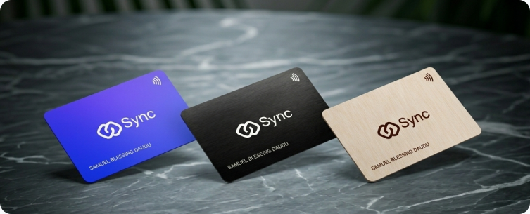 Three SYNC cards — metal, plastic and wood — on a marble surface